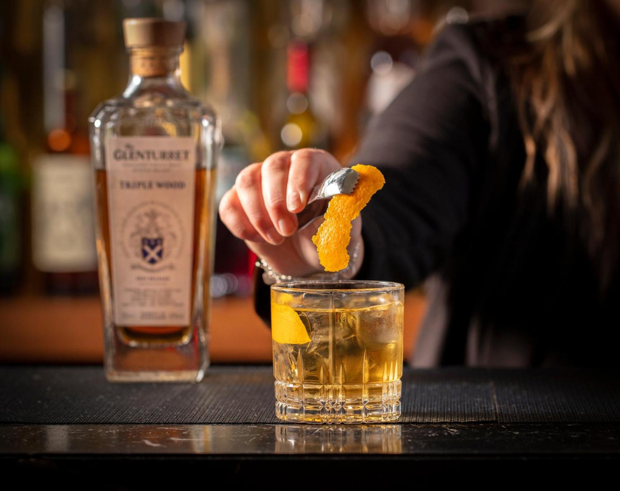 Schloss Roxburghe, Part Of Destination By Hyatt 外观 照片 A bartender adding a lemon twist to a glass of GINfinity